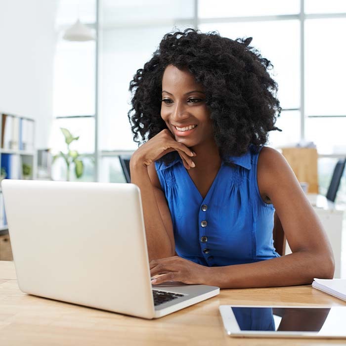 woman blue shirt laptop tablet